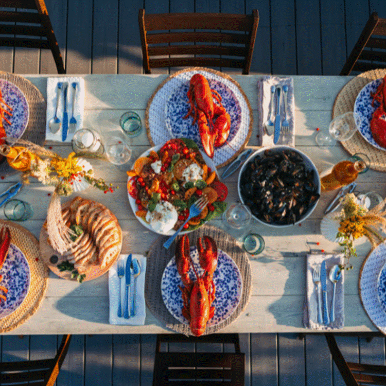 A table with plates of food and glasses
AI-generated content may be incorrect.